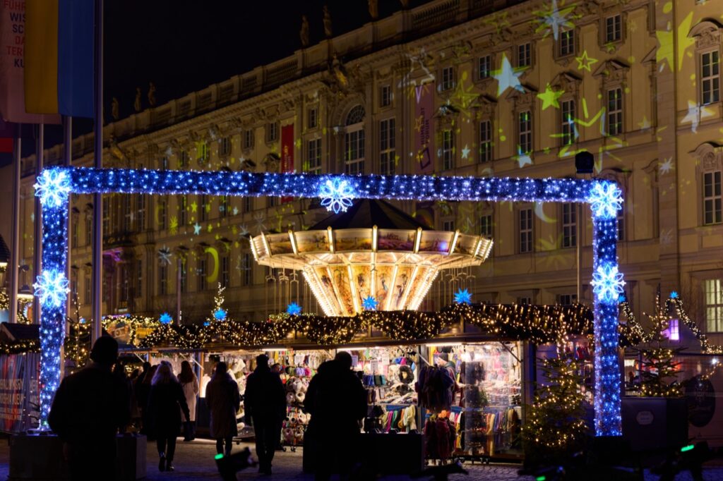 Germany Christmas markets at night: a carousel and illuminated archway at the Schlossplatz market in Berlin
