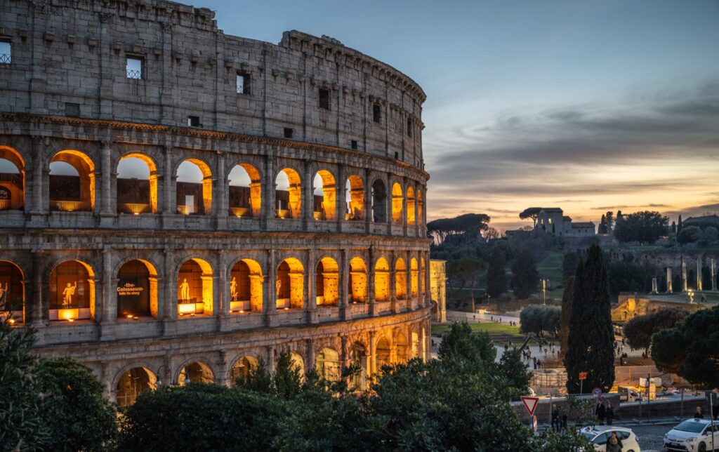 The Colosseum in Rome lit up at sunset, the first stop on a 10-day Rome, Florence and Venice itinerary