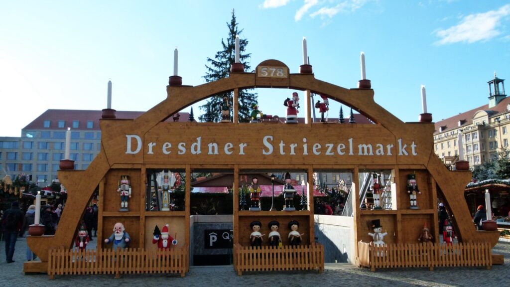 Giant wooden candle arch at the entrance to the Dresden Striezelmarkt, Germany's oldest Christmas market