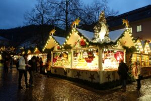 Glowing wooden stalls at the Heidelberg Christmas market at dusk, one of the best Christmas markets in Germany