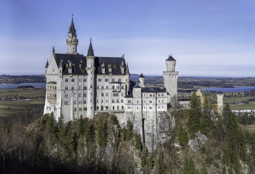 Neuschwanstein Castle on its rocky ridge above the Bavarian countryside, the highlight of any Bavaria road trip