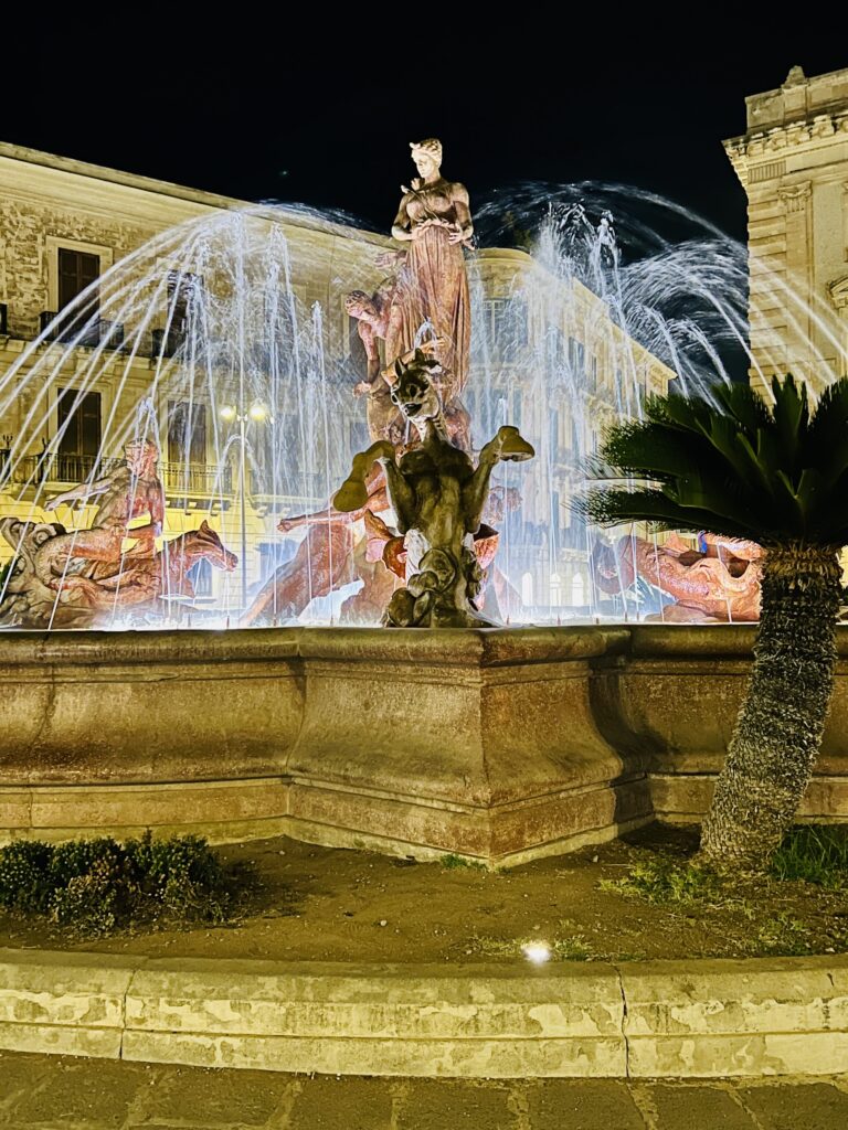 Fountain of Diana lit up at night in Piazza Archimede, Ortigia, Syracuse