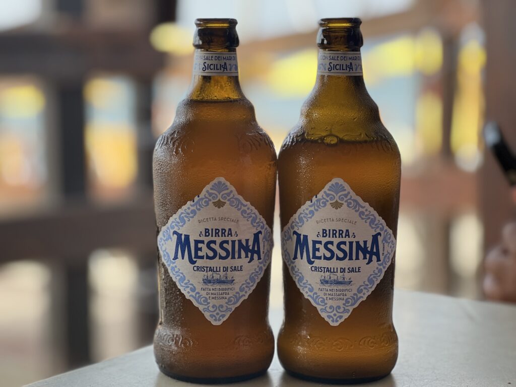 Two bottles of Birra Messina on the seafront in Cefalù