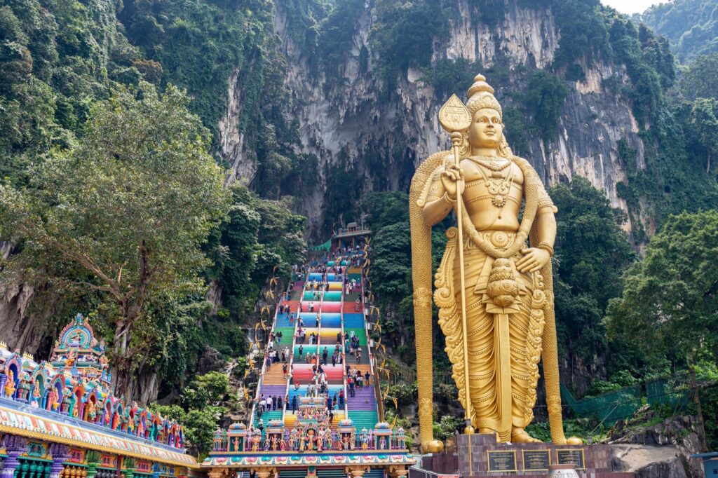 The golden Lord Murugan statue and the 272 rainbow-painted steps at Batu Caves