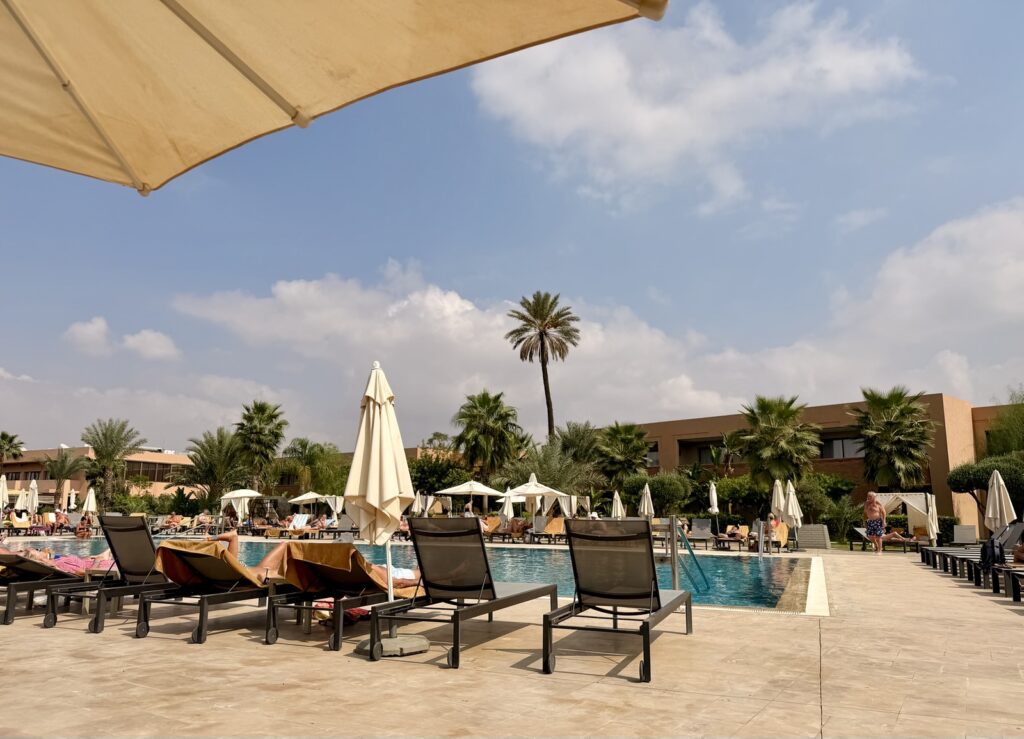 The main swimming pool, sun loungers and palm trees at the Be Live Collection Marrakech in the Palmeraie