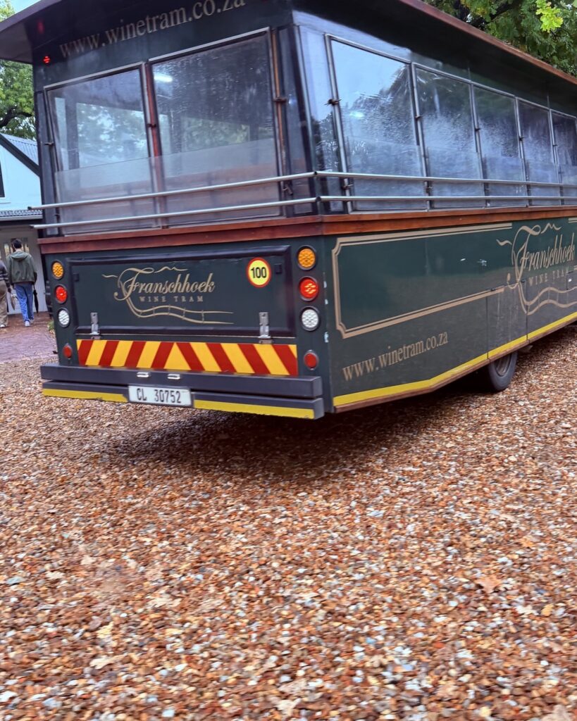 The Franschhoek Wine Tram waiting at one of its wine-estate stops in the Franschhoek Valley