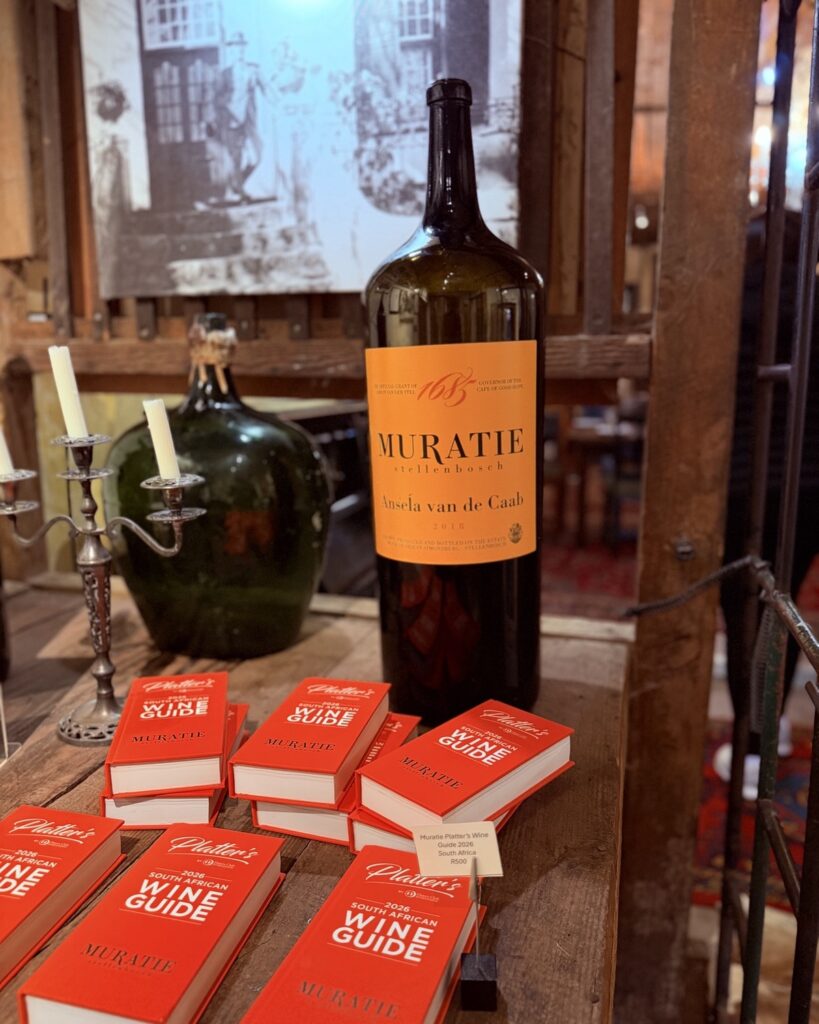 A bottle of Muratie wine and copies of Platter's wine guide in the old cellar tasting room at Muratie, Stellenbosch