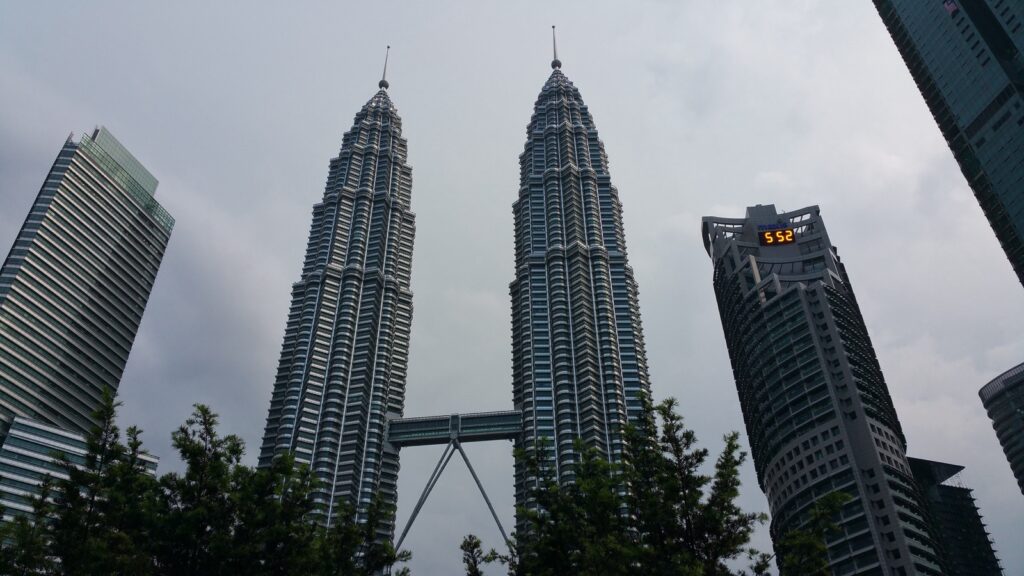 Looking up at the Petronas Twin Towers and their skybridge from the KLCC side