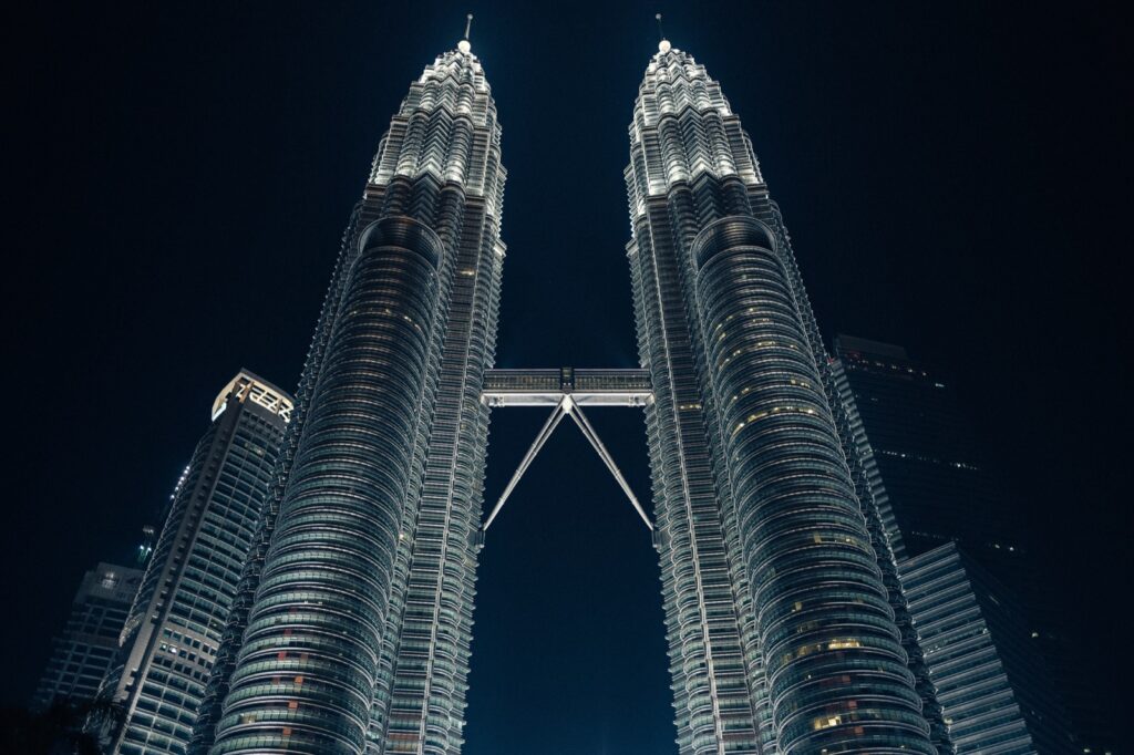 The Petronas Twin Towers lit up at night, the first stop on a 2-day Kuala Lumpur itinerary